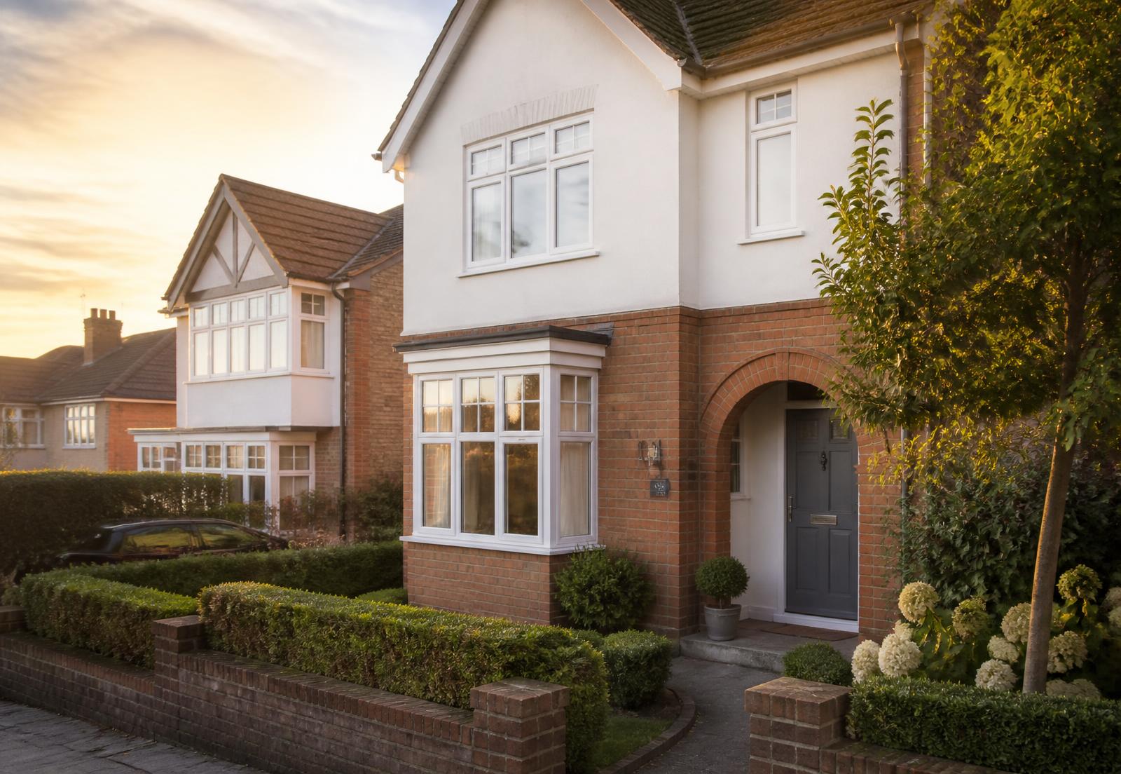 Warm, modern residential family home with a welcoming front garden in evening light